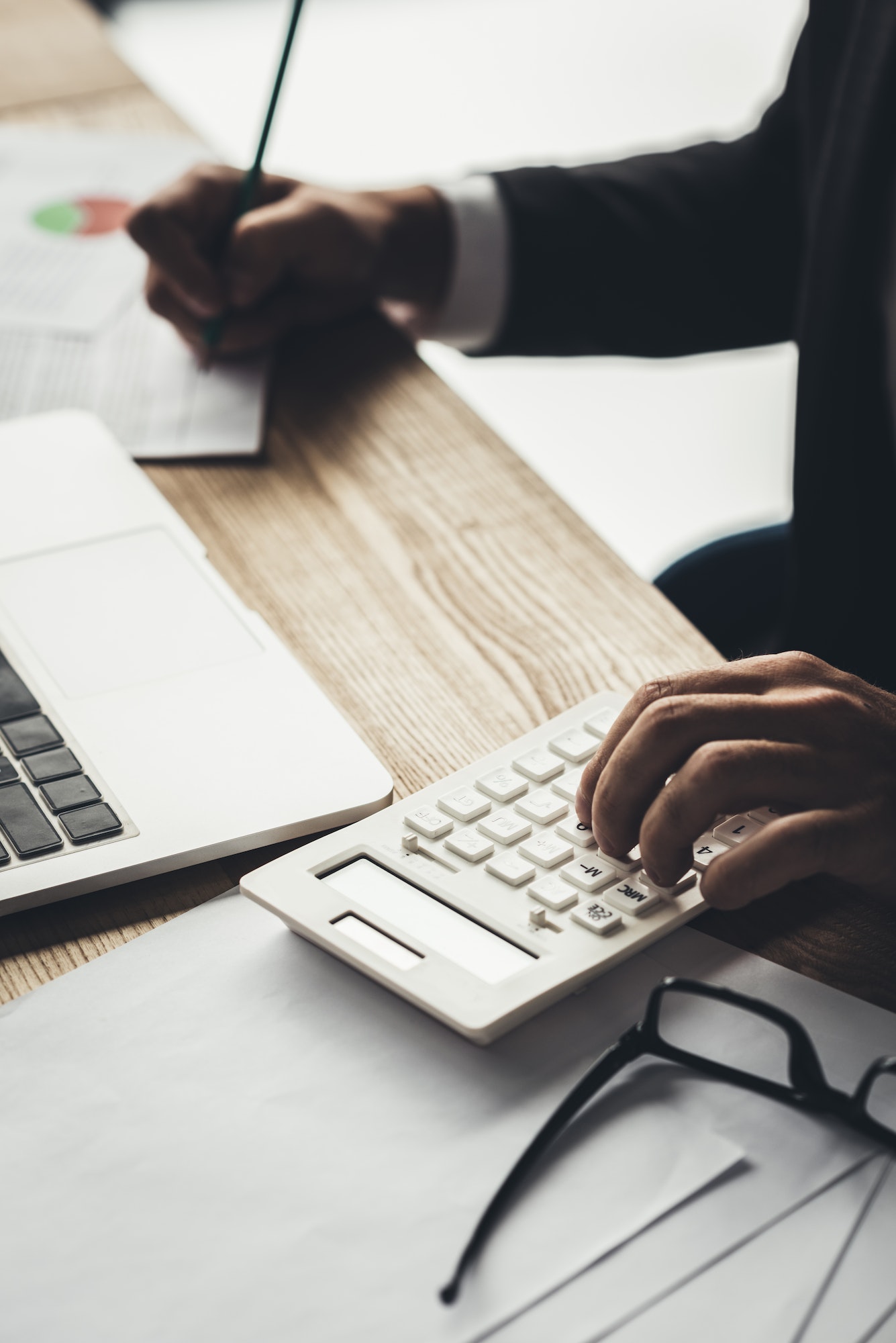 cropped shot of accountant using calculator